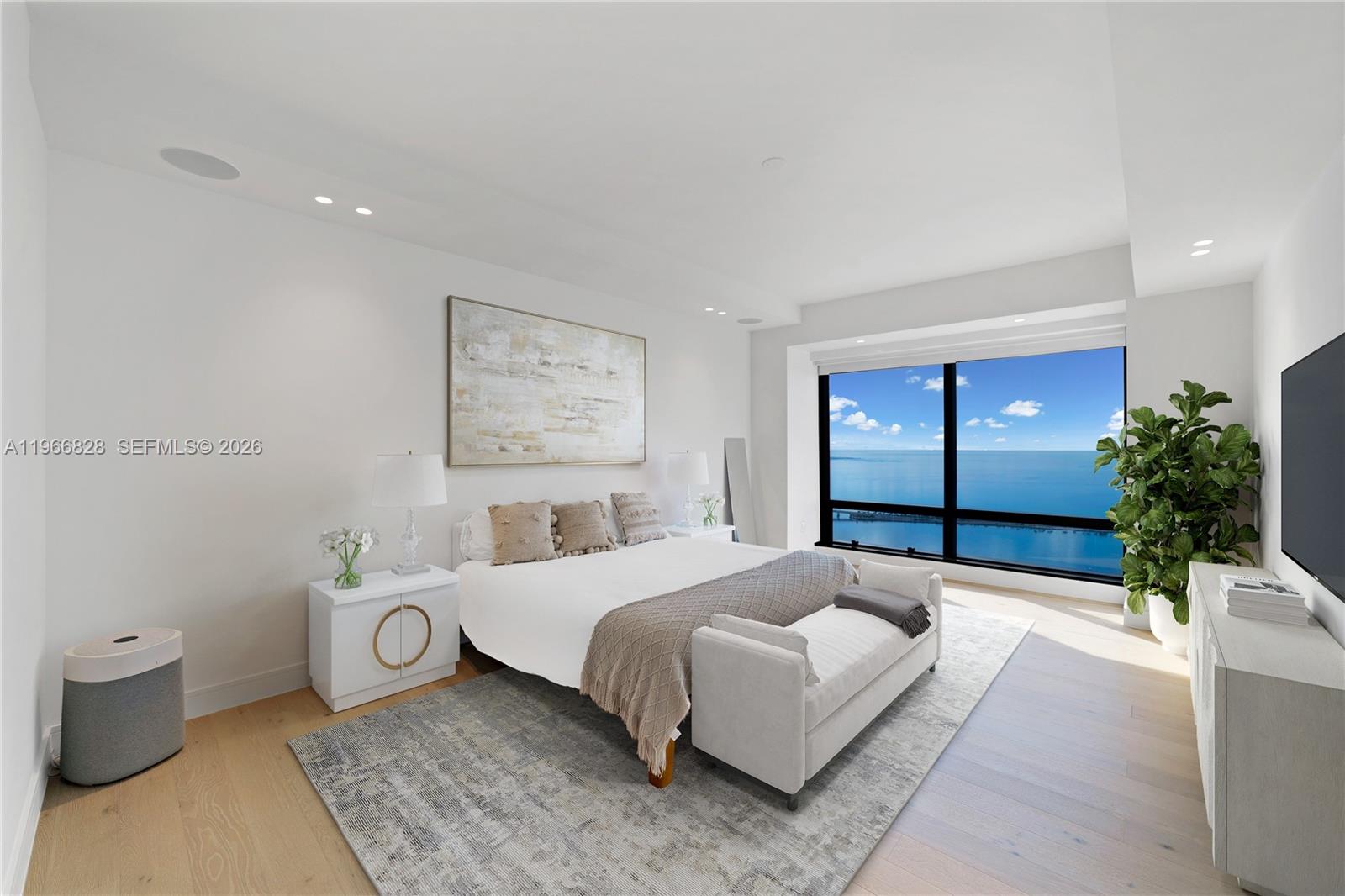 1425 Brickell Avenue, Unit 57A Miami, FL 33131 - Photo 13 of 35 a bedroom with a bed and a potted plant