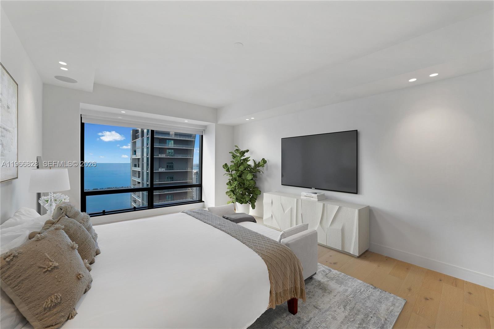 1425 Brickell Avenue, Unit 57A Miami, FL 33131 - Photo 14 of 35 a bedroom with a bed and a flat screen tv
