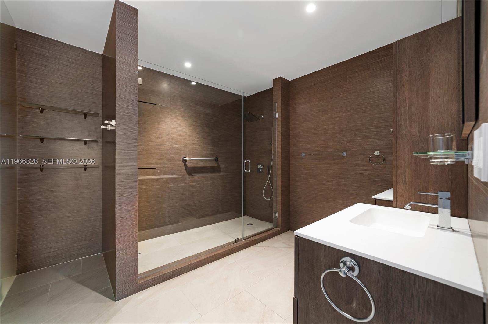 1425 Brickell Avenue, Unit 57A Miami, FL 33131 - Photo 16 of 35 a bathroom with a sink and a mirror