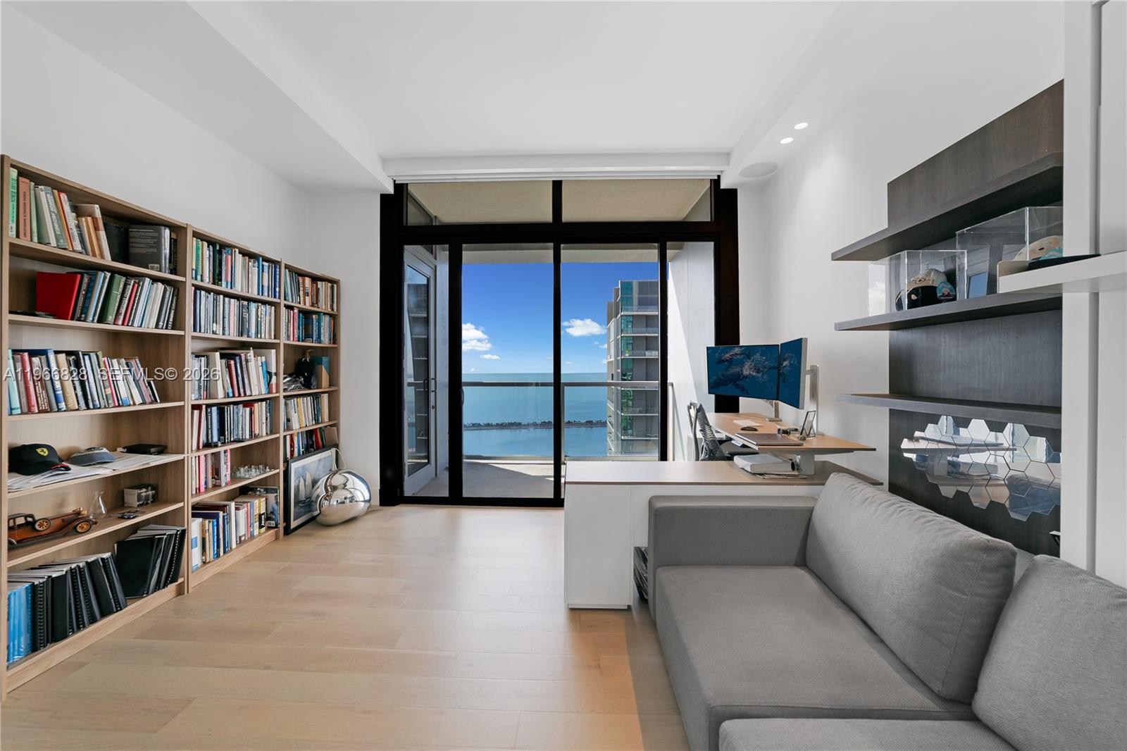 1425 Brickell Avenue, Unit 57A Miami, FL 33131 - Photo 19 of 35 a living room with a couch and a flat screen tv