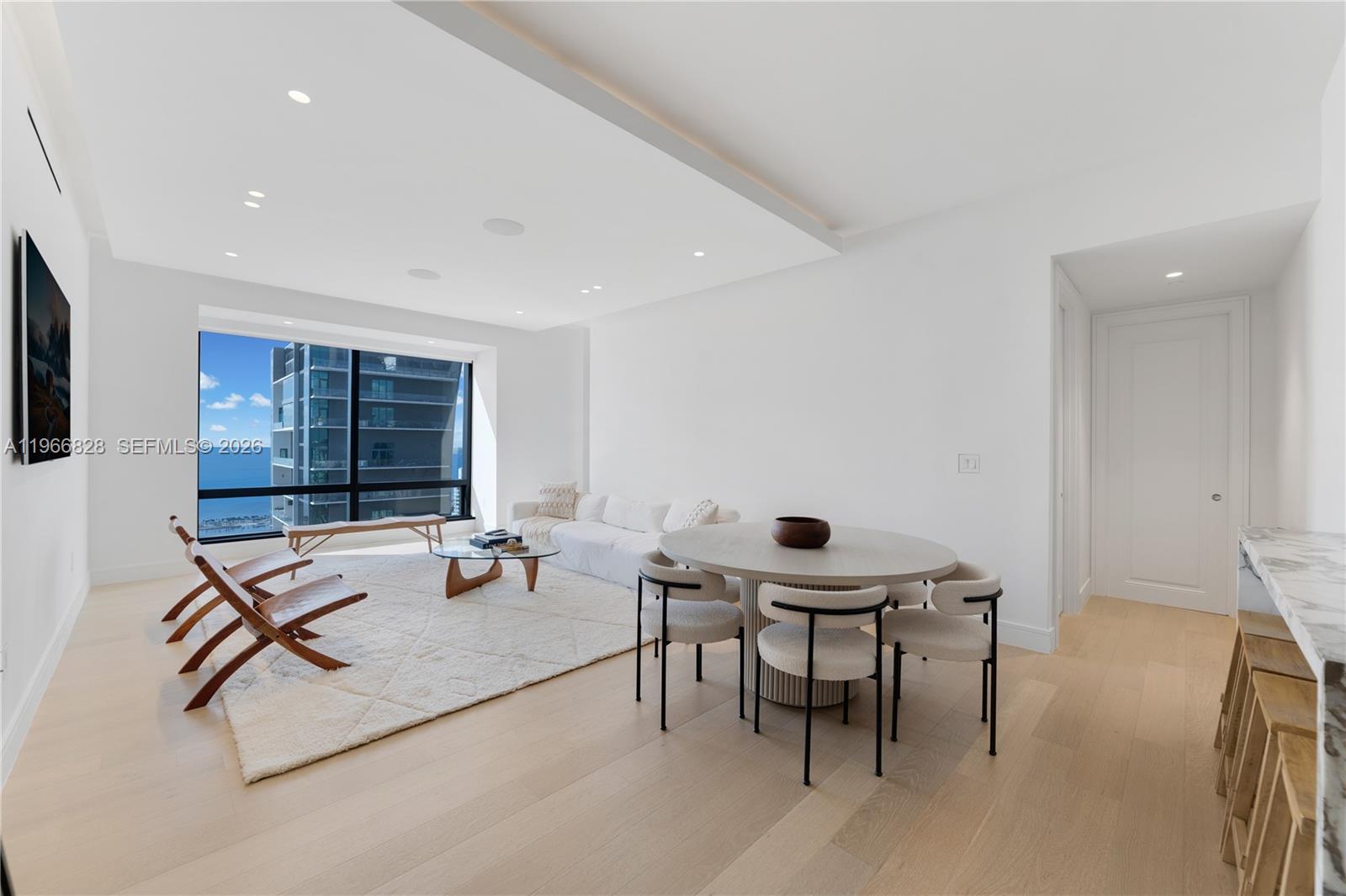 1425 Brickell Avenue, Unit 57A Miami, FL 33131 - Photo 2 of 35 a living room with furniture a table and a window
