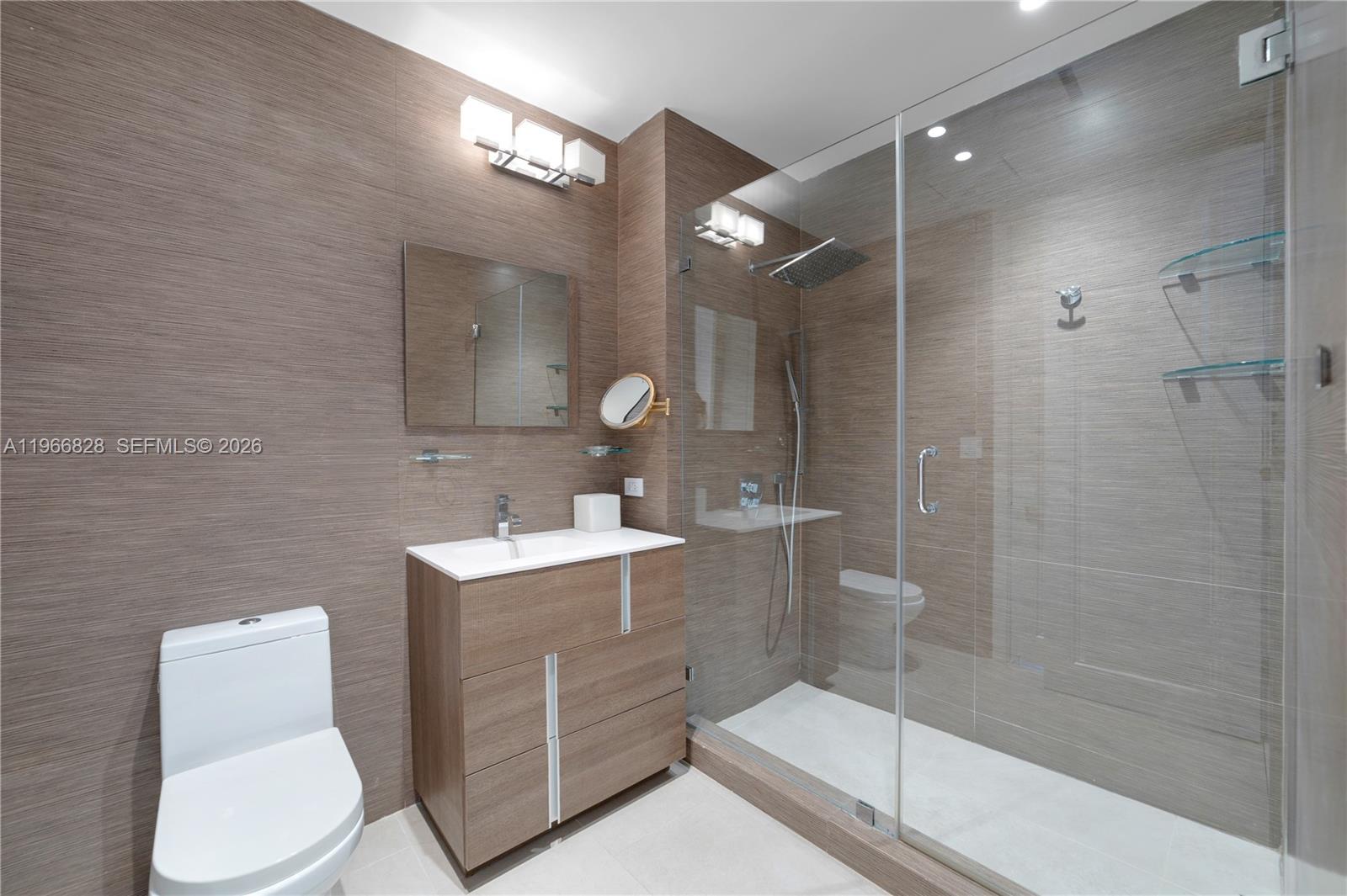 1425 Brickell Avenue, Unit 57A Miami, FL 33131 - Photo 21 of 35 a bathroom with a sink toilet and shower