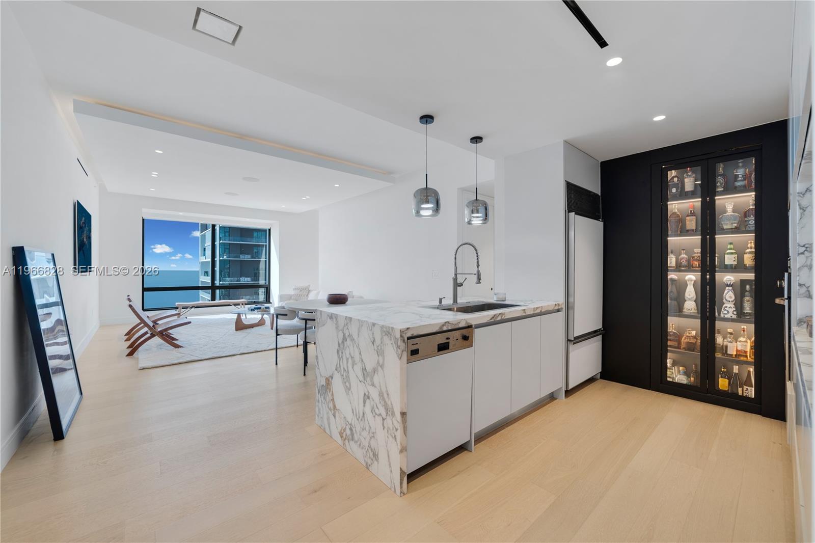 1425 Brickell Avenue, Unit 57A Miami, FL 33131 - Photo 23 of 35 a large white kitchen with sink a stove and a refrigerator