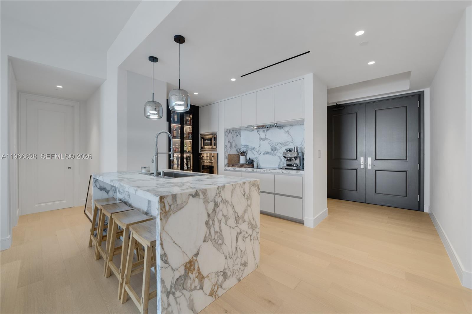 1425 Brickell Avenue, Unit 57A Miami, FL 33131 - Photo 24 of 35 a kitchen with stainless steel appliances kitchen island granite countertop a refrigerator and a stove top oven