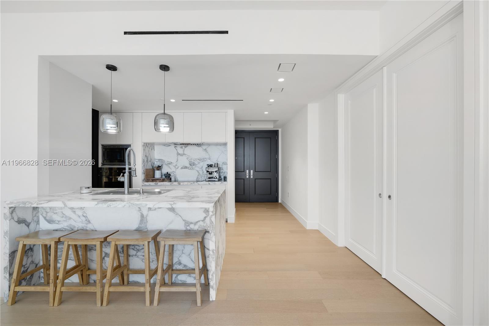 1425 Brickell Avenue, Unit 57A Miami, FL 33131 - Photo 7 of 35 a large kitchen with a table and chairs in it