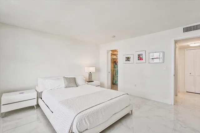 a bedroom with a bed and a wall painting