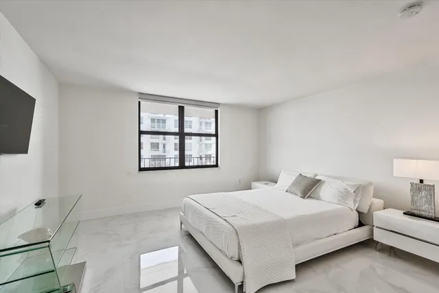 a bathroom with a toilet a sink a mirror and shower