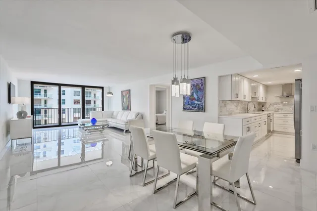 a room with stainless steel appliances kitchen island granite countertop furniture and a view of kitchen