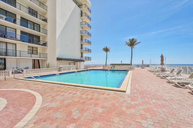 a view of a patio with swimming pool