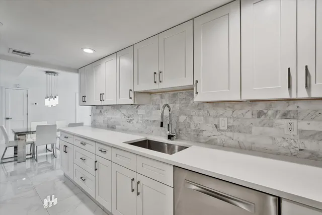 a kitchen with a sink and cabinets