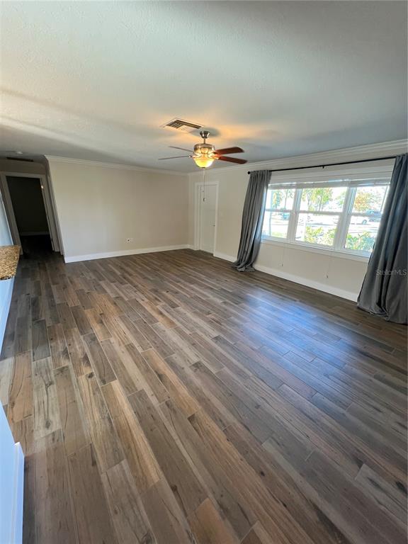 511 West Retta Esplanade Punta Gorda, FL 33950 - Photo 5 of 19 wooden floor in an empty room with a window