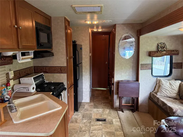 a kitchen with a refrigerator stove and microwave