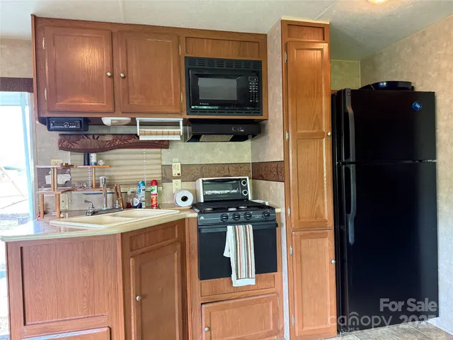 a view of a kitchen with a sink and cabinets
