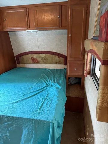 a bedroom with a bed and cabinets