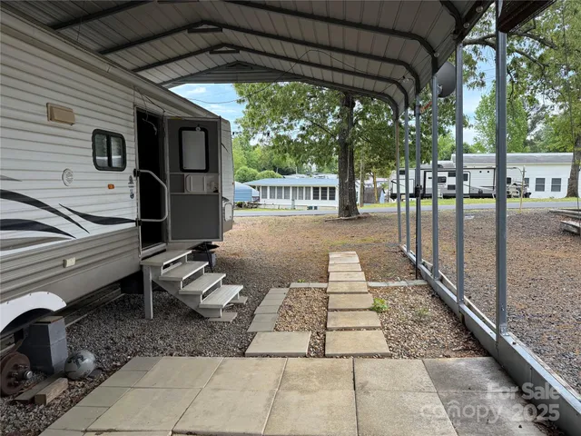 a view of a patio with table and chairs potted plants with wooden floor