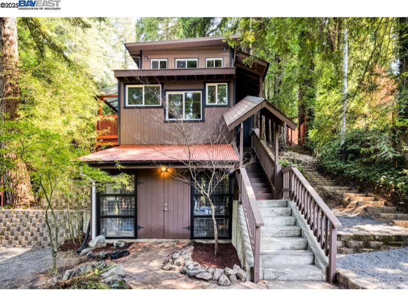a view of a house with large windows and a small yard
