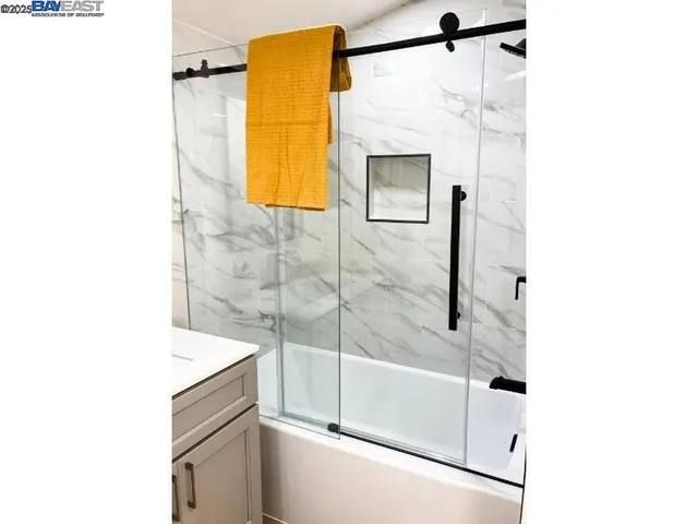 a bedroom with a bed and a night stand