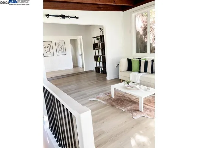 a dining room with furniture and floor to ceiling window