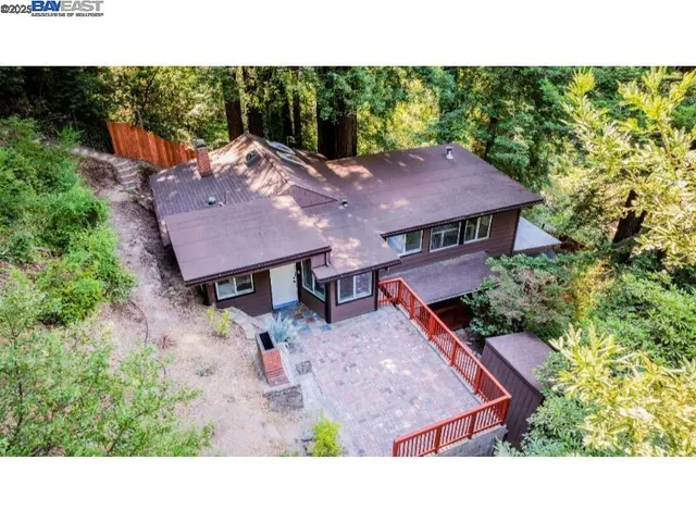 view of a house with a yard balcony and sitting area