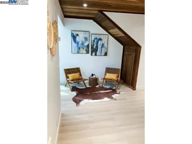 a view of living room with furniture and wooden floor