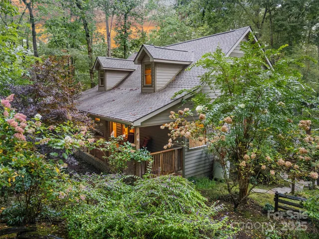 front view of a house with a tree