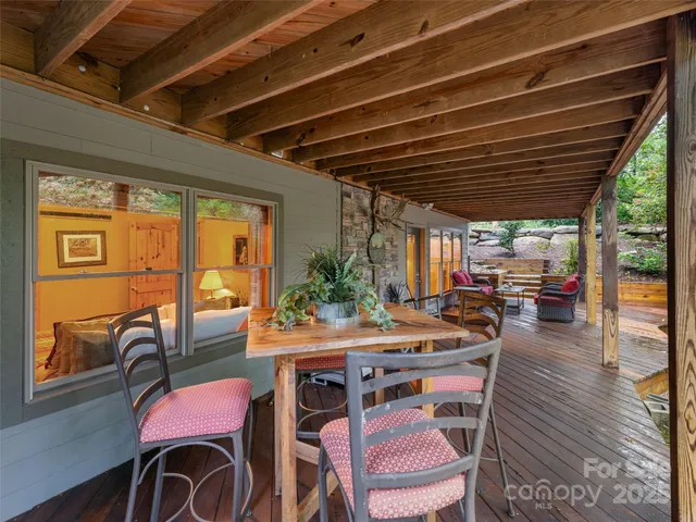 a outdoor dining space with furniture and wooden floor