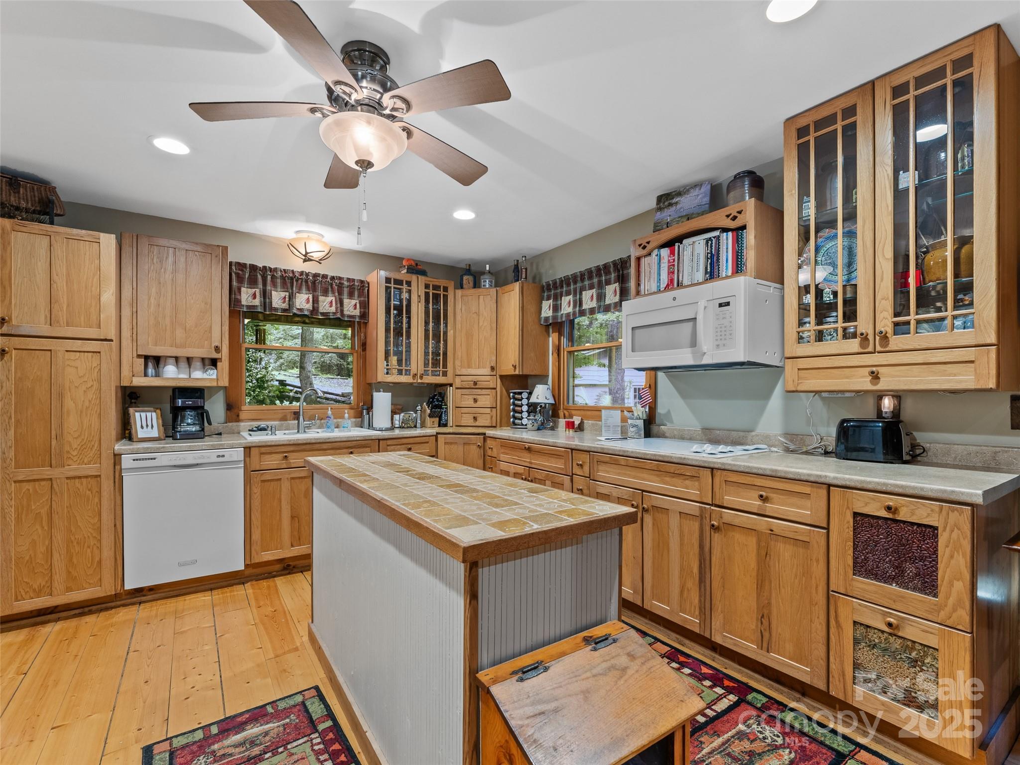 779 Thissa Way Brevard, NC 28712 - Photo 16 of 44 a kitchen with stainless steel appliances granite countertop a refrigerator a sink dishwasher a stove with white cabinets and wooden floor