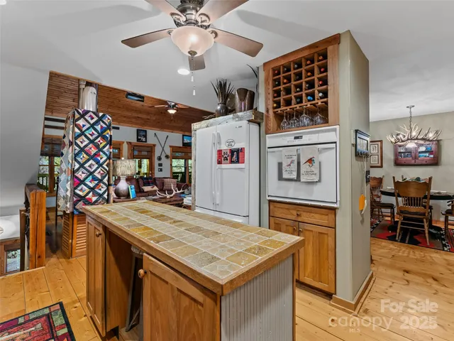a room with stainless steel appliances kitchen island a table and chairs in it