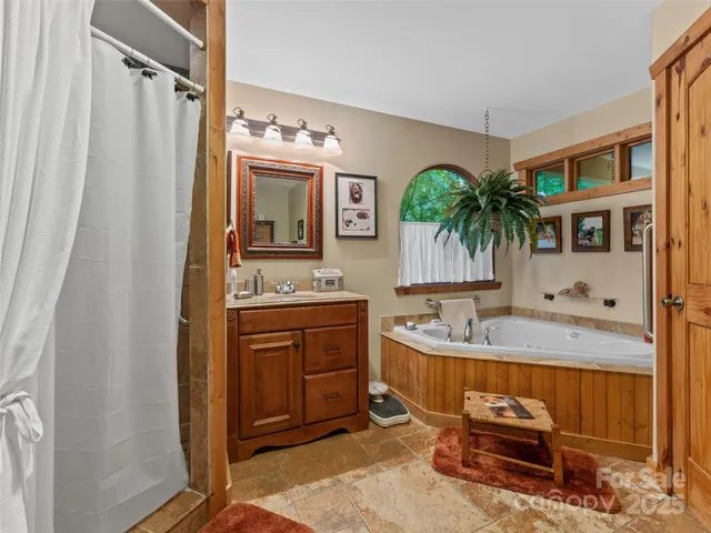 a bathroom with a granite countertop sink a mirror a vanity and a shower
