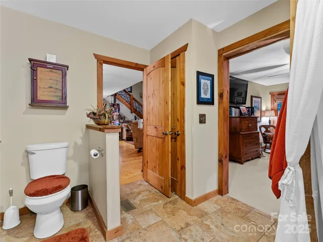 a bathroom with a toilet and a shower