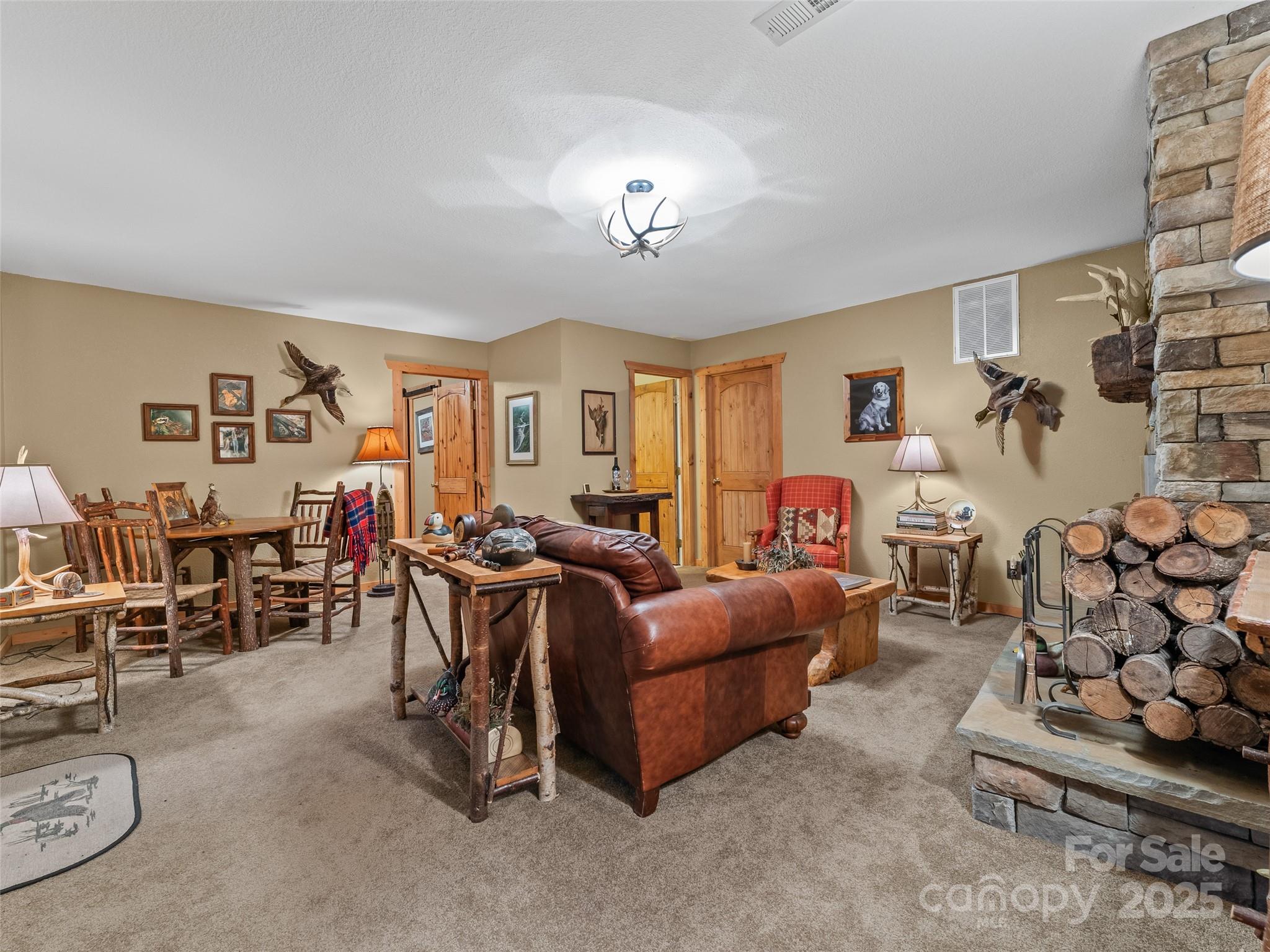 779 Thissa Way Brevard, NC 28712 - Photo 29 of 44 a living room with furniture a rug and a chandelier