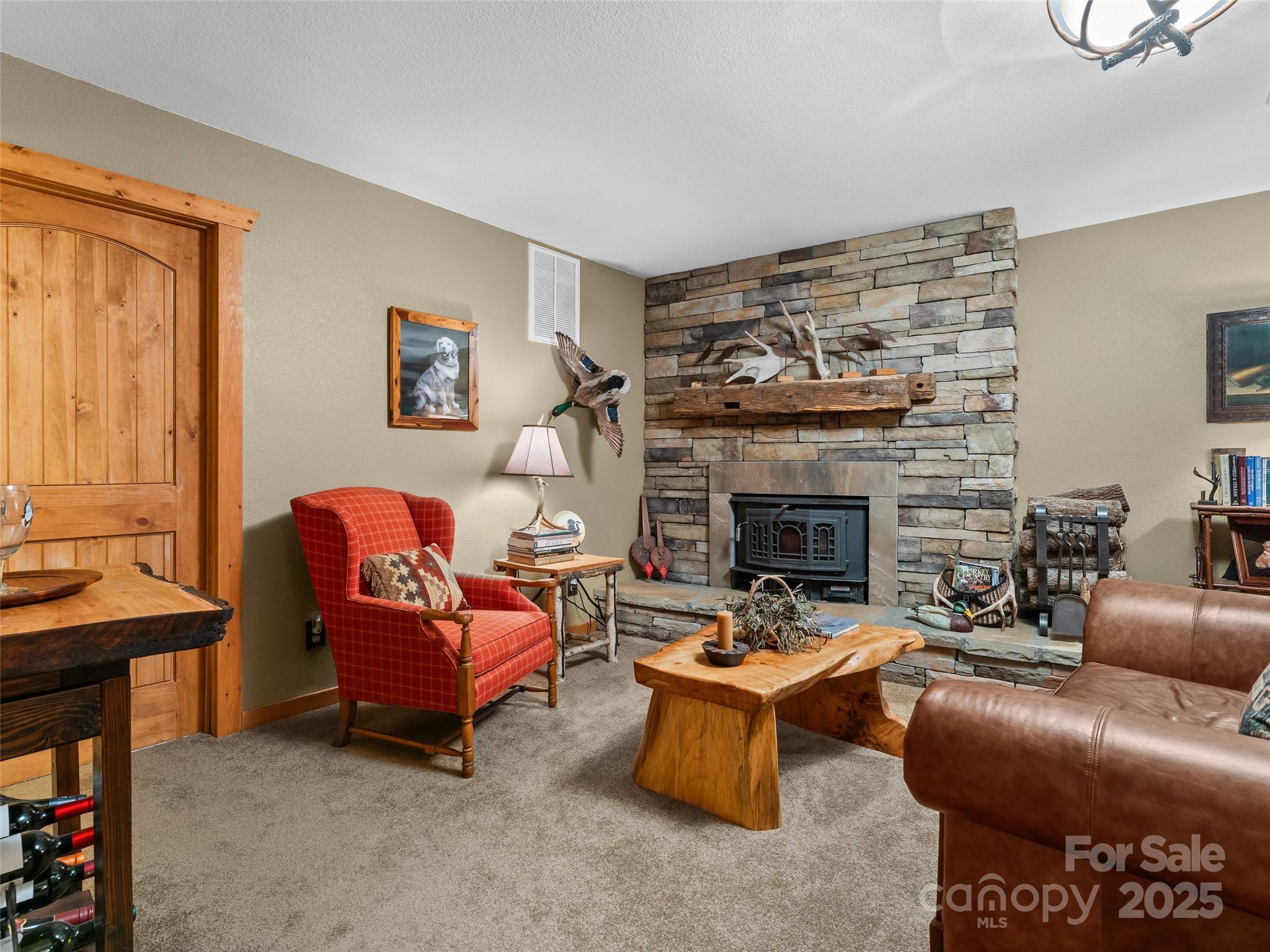 779 Thissa Way Brevard, NC 28712 - Photo 30 of 44 a living room with furniture a fireplace and a flat screen tv