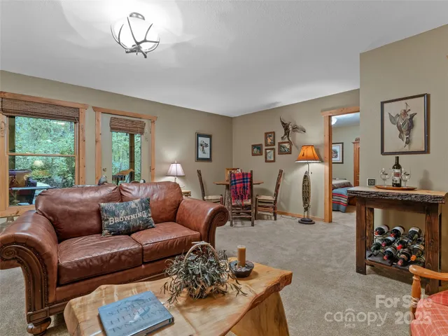 a living room with furniture a rug and a window