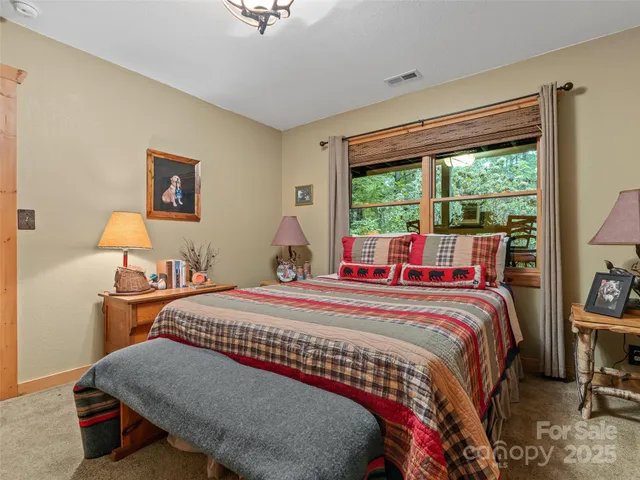 a bedroom with a bed and a large window