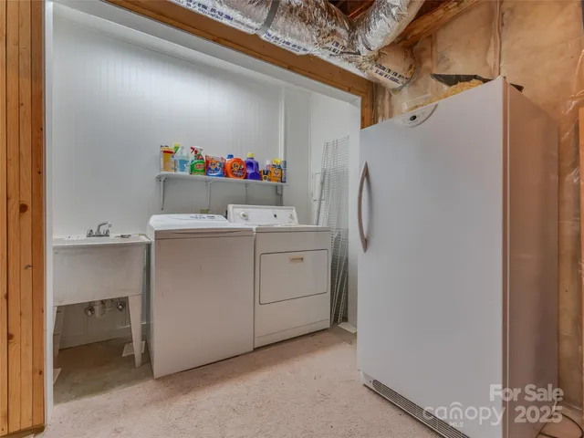 a utility room with cabinets washer and dryer