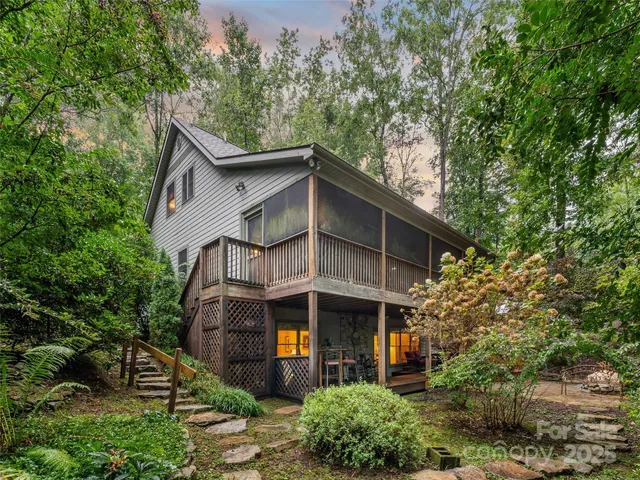 a house that has a tree in front of it