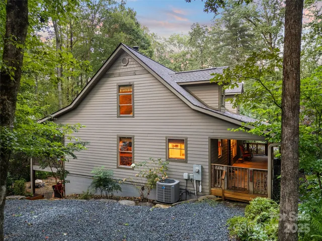 a backyard of a house with barbeque oven and outdoor seating
