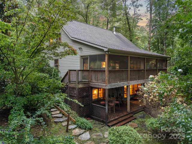 a view of a house with a balcony wooden floor and a table and chairs