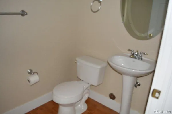 a bathroom with a sink toilet and a mirror