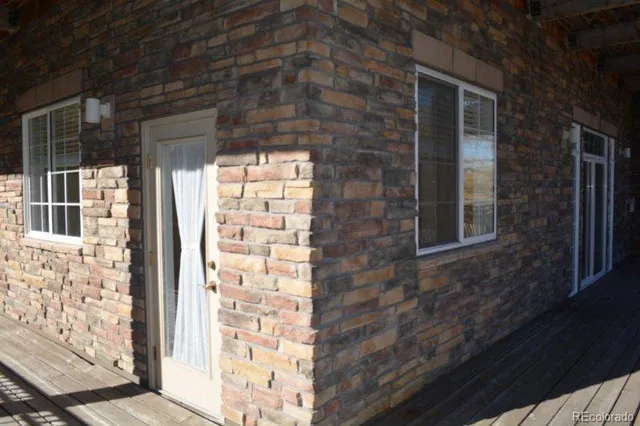 a view of a brick house with a large window