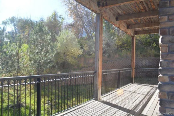 a view of a balcony with a floor to ceiling window and wooden floor