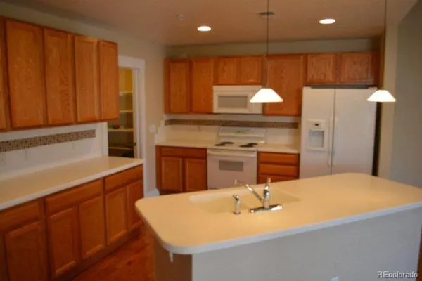 a kitchen with a sink cabinets and appliances