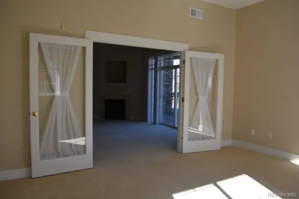 an empty room with an entrance to other room