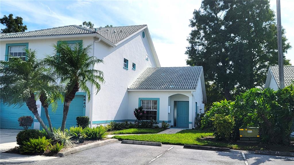 6640 Pineview Terrace, Unit 6640 Bradenton, FL 34203 - Photo 1 of 80 a front view of a house with a garden