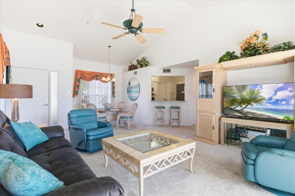 6640 Pineview Terrace, Unit 6640 Bradenton, FL 34203 - Photo 15 of 80 a living room with furniture and a flat screen tv