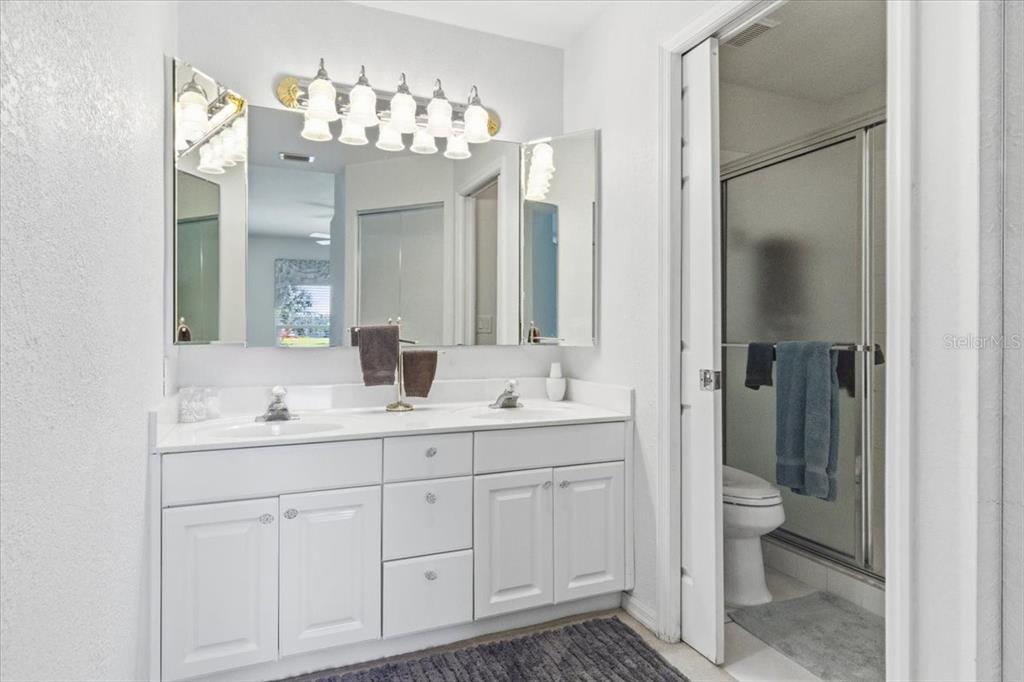 6640 Pineview Terrace, Unit 6640 Bradenton, FL 34203 - Photo 28 of 80 a bathroom with a double vanity sink and a mirror