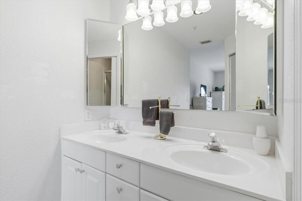 6640 Pineview Terrace, Unit 6640 Bradenton, FL 34203 - Photo 29 of 80 a bathroom with a sink vanity and a mirror