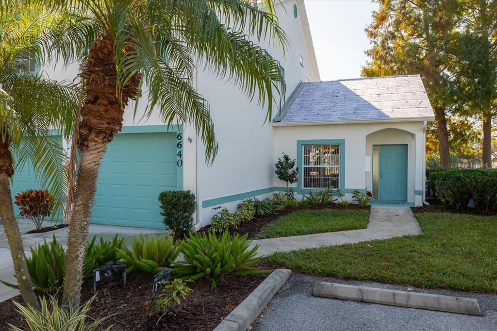 6640 Pineview Terrace, Unit 6640 Bradenton, FL 34203 - Photo 4 of 80 a front view of a house with garden