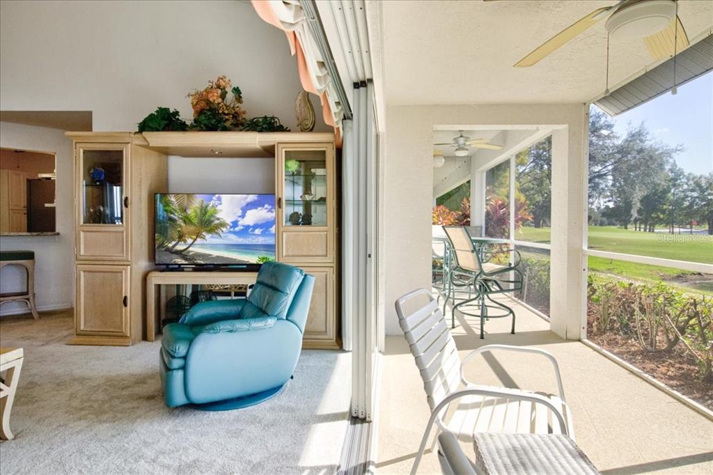 6640 Pineview Terrace, Unit 6640 Bradenton, FL 34203 - Photo 42 of 80 a living room with fireplace furniture and a floor to ceiling window