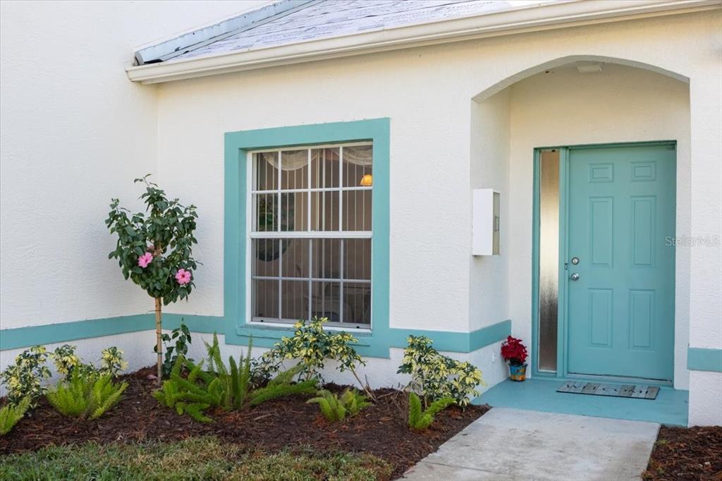 6640 Pineview Terrace, Unit 6640 Bradenton, FL 34203 - Photo 7 of 80 a house with flowers in front of it